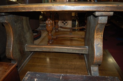 Lot 1344 - A provincial elm dining table, the twin plank...