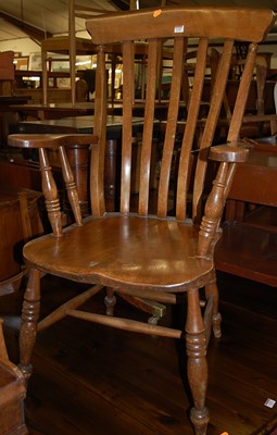 Lot 1320 - An elm seated lath back open armchair