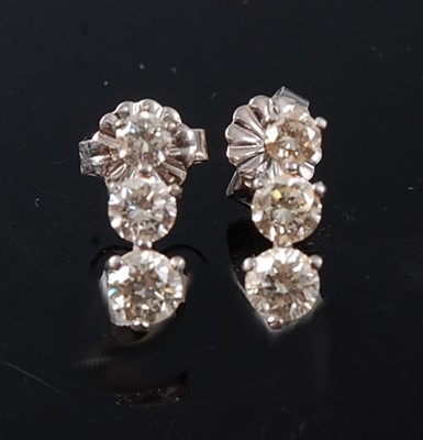 Lot 2208 - A pair of white metal diamond three-stone drop...