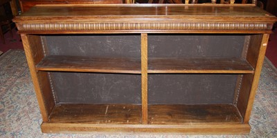 Lot 1323 - A large oak freestanding dwarf bookshelf,...