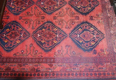Lot 1148 - A Persian woollen red ground rug, 190 x 151cm