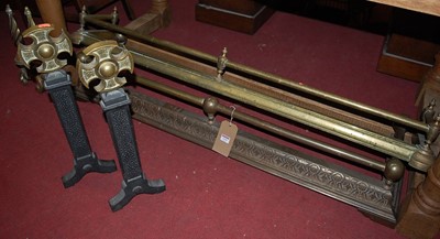 Lot 1291 - Two circa 1900 brass and iron fire fenders;...