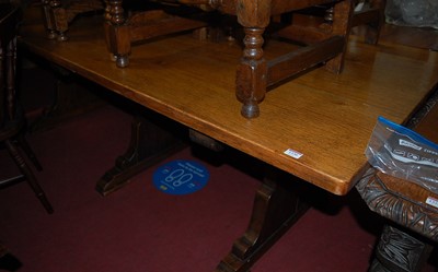 Lot 1330 - A large plank top oak trestle end refectory...