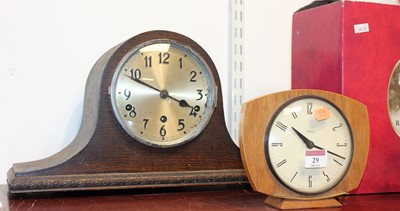 Lot 29 - A 1930s oak cased mantel clock, having a...