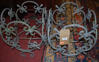 Lot 1364 - A pair of wrought metal floral design planter...