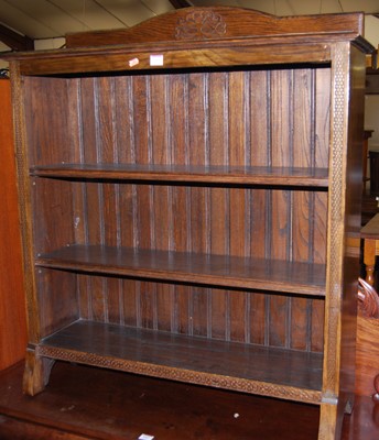 Lot 1426 - A 1930s oak ledgeback low freestanding open...