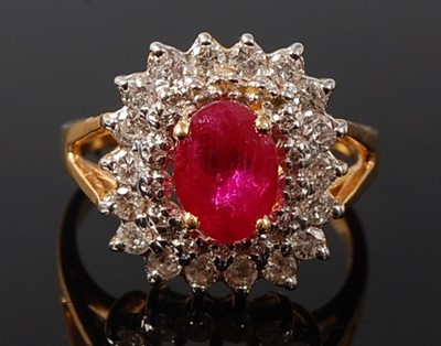 Lot 2225 - A yellow metal, ruby and diamond oval cluster...