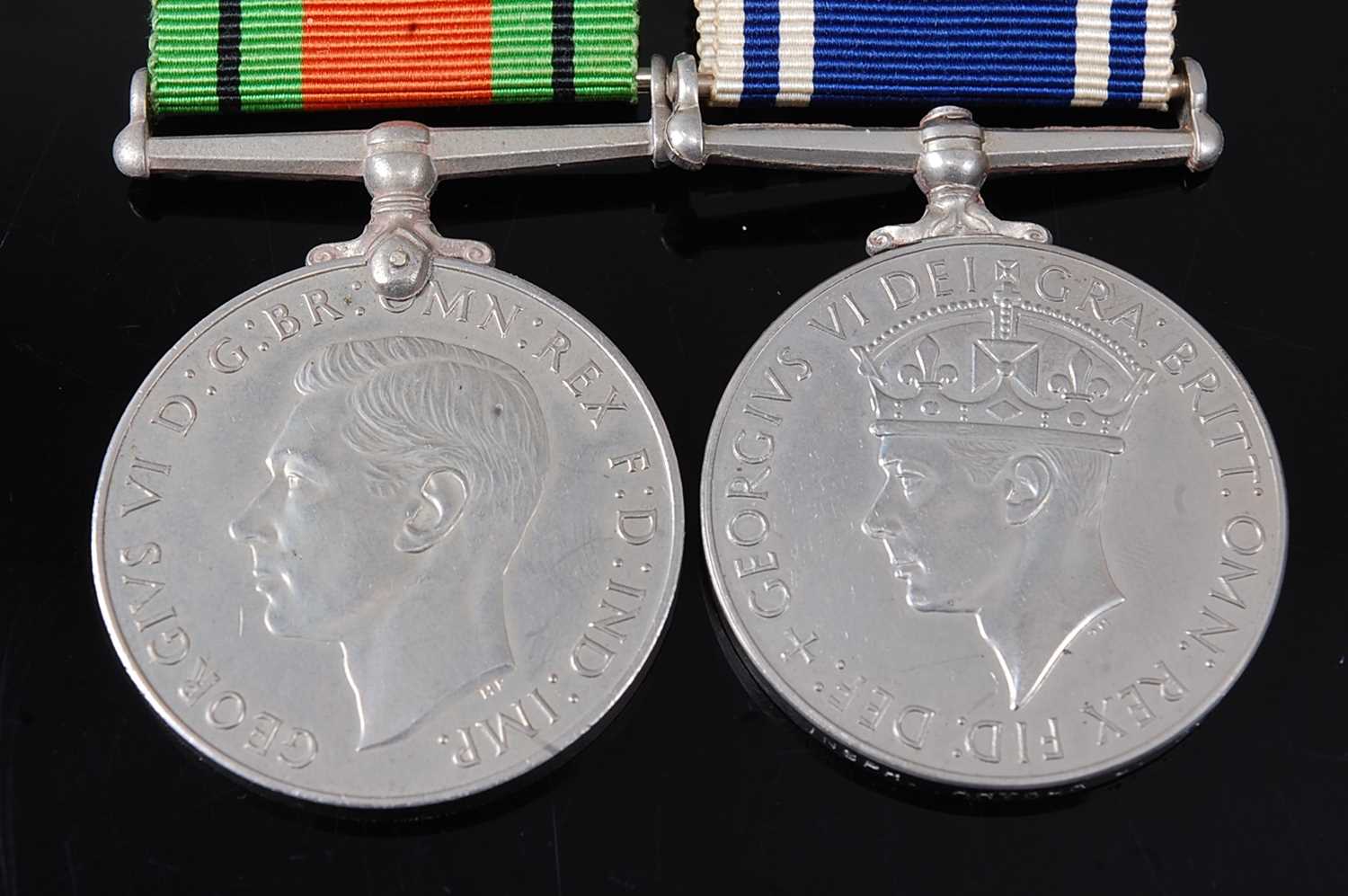 Lot 39 - A WW II Defence medal, together with a George...