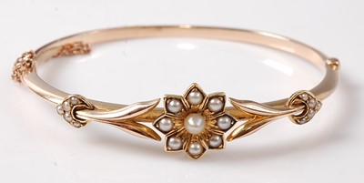 Lot 2277 - A yellow metal oval hinged hollow bangle with...