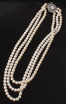 Lot 2253 - A three-row pearl necklet, comprising three...