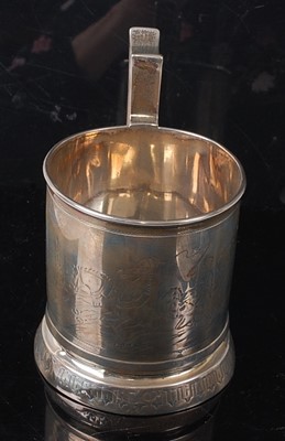 Lot 2149 - A Russian silver mug, bright cut engraved with...