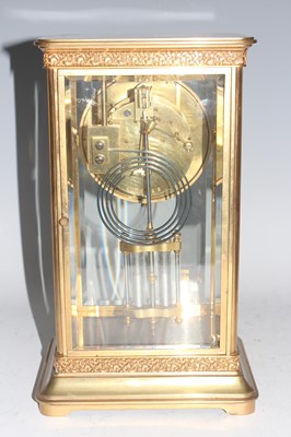 Lot 28 - A circa 1900 gilt brass four glass clock by...