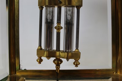 Lot 28 - A circa 1900 gilt brass four glass clock by...