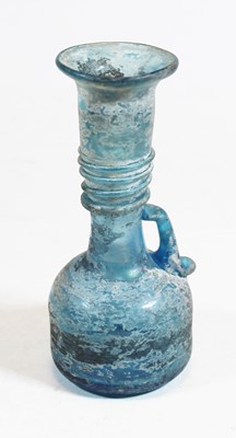 Lot 265 - A Roman style blue glass bottle, the flared...