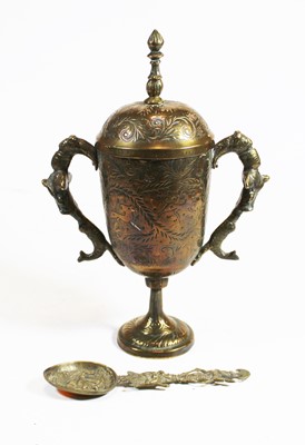 Lot 264 - An eastern brass cup and cover, the finial...