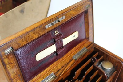 Lot 112 - An early 20th century oak stationery box, the...
