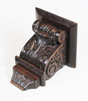 Lot 169 - An early 20th century carved dark oak bracket,...
