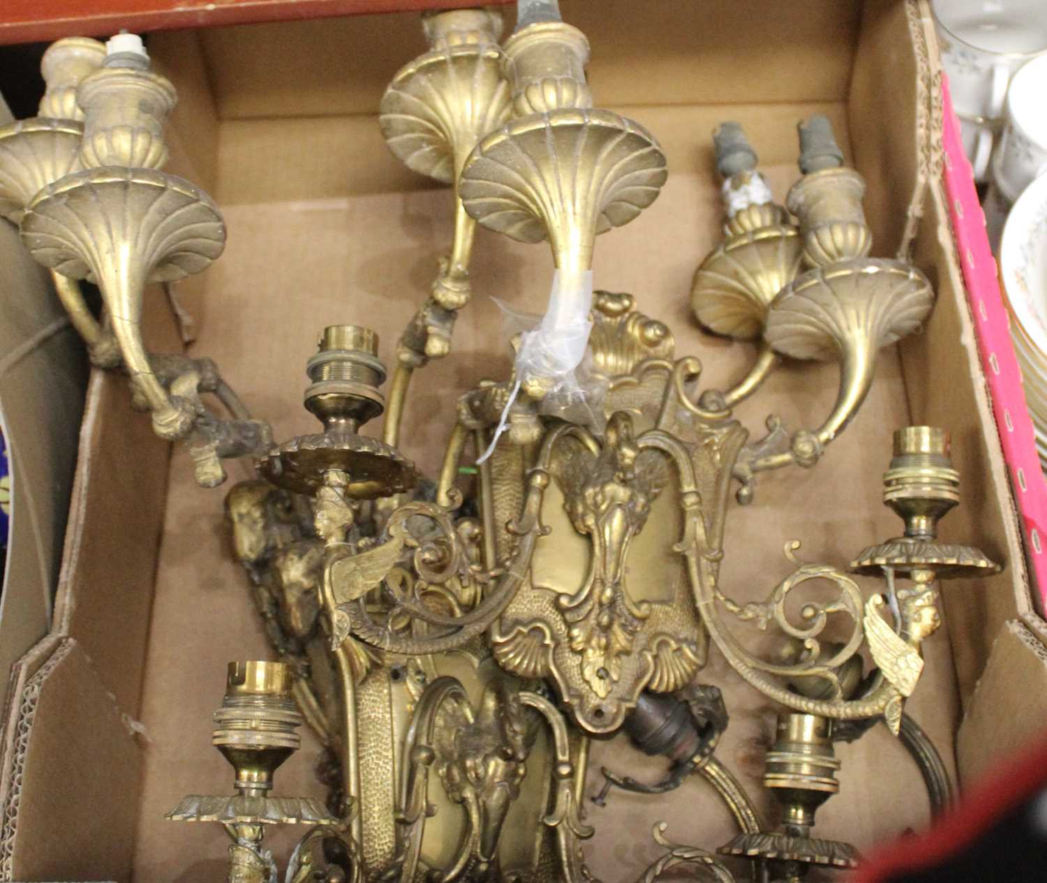 Lot 131 - A pair of Rococo style gilt brass twin sconce...