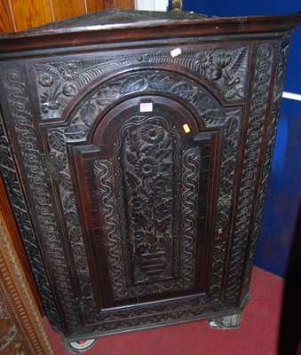 Lot 1103 - A 19th century floral relief carved oak...