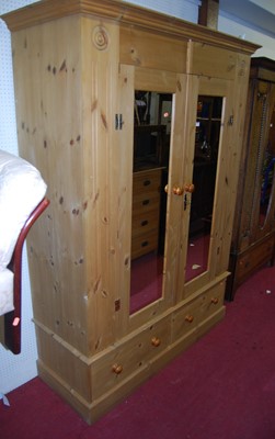 Lot 1116 - A modern pine double mirror door wardrobe...