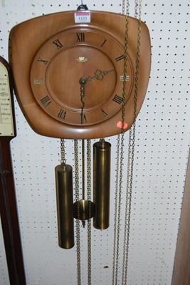 Lot 1121 - A 1950s walnut hanging open wall clock, having...