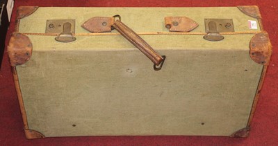 Lot 252 - A canvas clad and leather bound suitcase;...