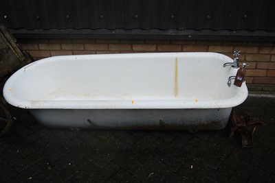Lot 1137 - An early 20th century cast iron roll top bath...
