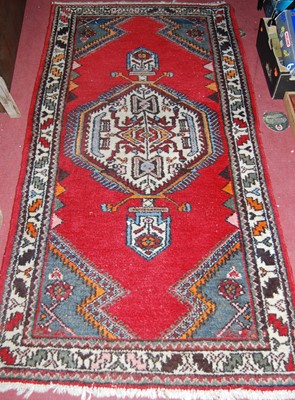 Lot 1145 - A Turkish woollen red ground rug with all over...