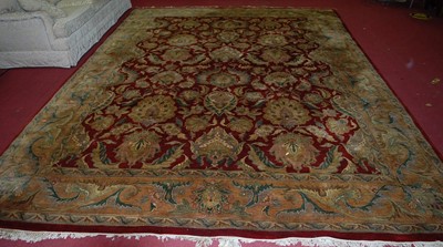 Lot 1146 - A large Chinese Superwash red ground carpet...
