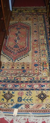 Lot 1147 - A Turkish cream ground woollen rug, the...