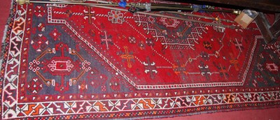 Lot 1149 - A Turkish woollen red ground rug, having all...