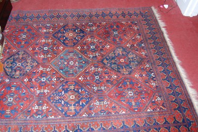 Lot 1154 - A Persian woollen red ground Bokhara rug, the...