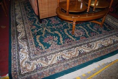 Lot 1155 - An Indian green ground large carpet, the...