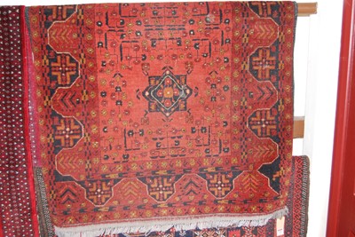 Lot 1156 - A Persian woollen red ground rug, 150 x 100cm