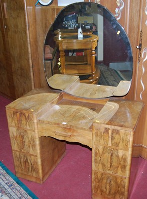Lot 1166 - An Art Deco figured walnut kneehole mirror...