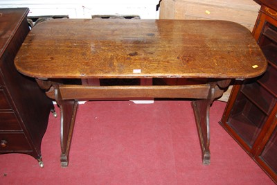 Lot 1183 - An early 20th century oak round cornered...