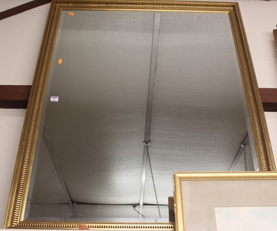 Lot 1028 - A gilt framed and bevelled rectangular wall...