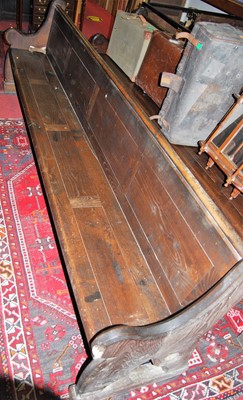 Lot 1204 - A late Victorian stained oak long church pew...