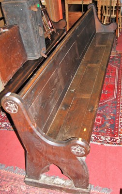 Lot 1205 - A late Victorian stained oak long church pew,...