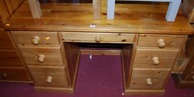 Lot 1217 - A modern pine round cornered kneehole writing...