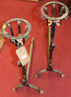 Lot 1076 - A pair of wrought iron and black enamelled...