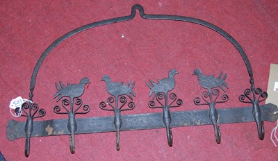 Lot 1256 - A decorative iron six hook wall mounted coat...