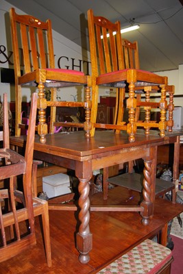 Lot 1297 - A 1930s barleytwist oak drawleaf dining table;...