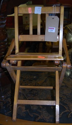 Lot 1304 - A slatted beech folding dolls chair