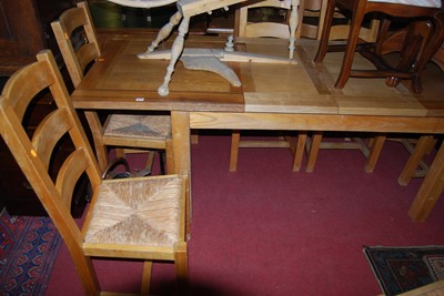 Lot 1319 - A modern light oak dining suite, comprising;...