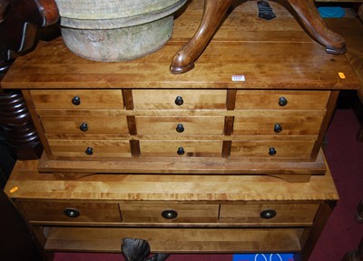 Lot 1335 - A contemporary hardwood low chest, fitted with...