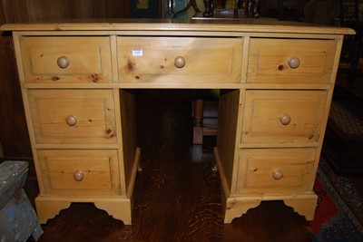 Lot 1355 - A modern pine kneehole dressing table, having...