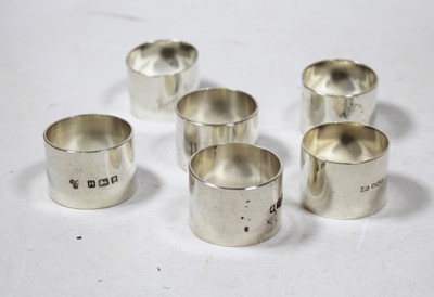 Lot 255 - A set of three plain heavy silver napkin rings,...