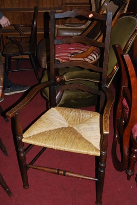 Lot 1403 - An early 20th century oak ladderback rush seat...