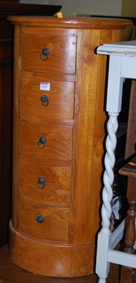 Lot 1416 - A contemporary circular hardwood five drawer...